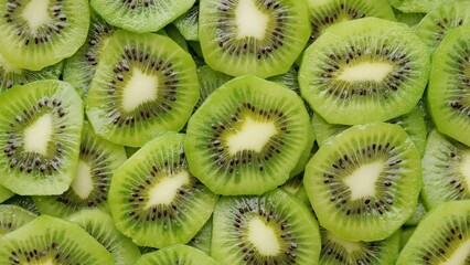 Poster - Heap of Sliced kiwi fruits top view. Fresh and healthy food concept
