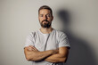© Dusan Petkovic - Portrait of a serious man with arms crossed looking at the camera.
