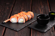 Sushi roll philadelphia with salmon and cucumber and cream cheese on black background. Sushi menu. Japanese food concept