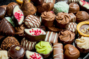 Poster - Chocolate candies with nuts and various fillings.