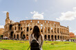 young woman in front of roman colosseum