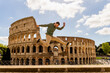 tourist on vacation in rome jumping happy in front of the roman colosseum