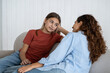 © DimaBerlin - Relaxed optimistic woman and school age girl talking and sharing secrets sits on sofa indoors. Casual mom and teenage daughter with slight smile talk about important topics and discuss child friends