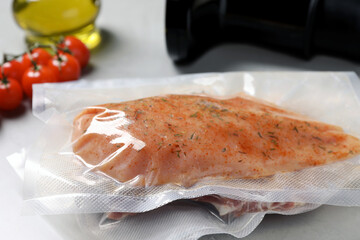 Vacuum packing with meat on white table, closeup. Sous vide cooking