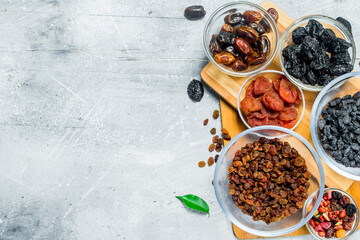 Poster - Assortment of different types of dried fruits in bowls.