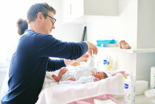 Father Preparing Newborn Baby For The First Bath