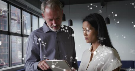 Wall Mural - Animation of molecular structures floating against diverse man and woman discussing at office