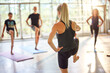 © Flamingo Images - Teacher leading students in a yoga class