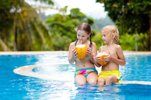 Child With Coconut Drink. Kids In Swimming Pool.