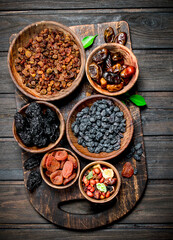 Sticker - Assortment of different kinds of dried fruits in bowls.