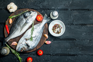 Poster - Raw sea fish dorado with spices and vegetables.