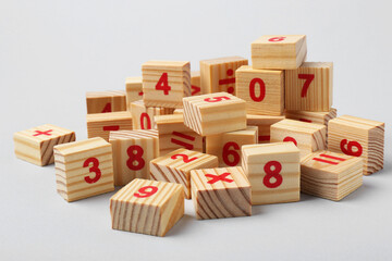 Wall Mural - Wooden cubes with numbers and mathematical symbols on light background