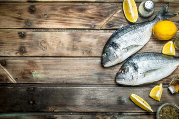 Poster - Raw sea fish with lemon slices and aromatic spices.