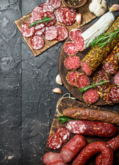 Wall Mural - Assortment of different salami with spices and herbs.