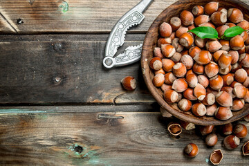 Poster - Hazelnuts in a bowl with a Nutcracker.