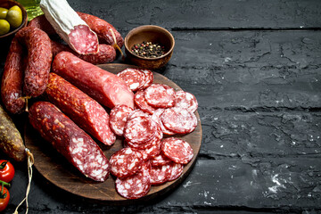 Wall Mural - Different types of salami on the Board.