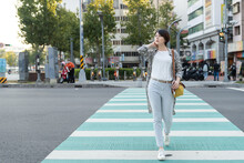 Full Length Of Young Asian Office Lady Walking On Zebra Cross Going To Work In Busy City Urban.