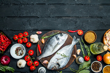 Wall Mural - Raw sea fish dorado with spices and vegetables.