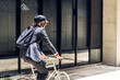 © Art_Photo - Portrait of hipster handsome businessman in suit with backpack looking forward while commuting riding bicycle on the street city way go to work.business travel transport bike concept.