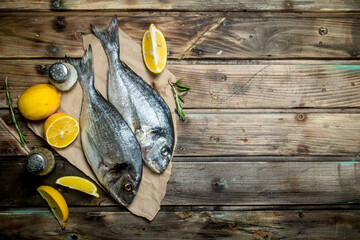 Wall Mural - Raw sea fish dorado with lemon, herbs and aromatic spices.