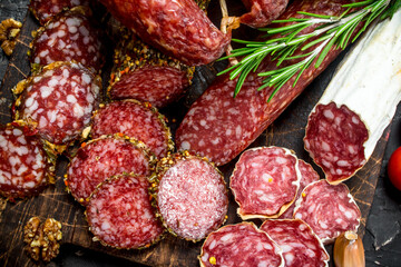 Wall Mural - Different types of smoked salami with aromatic seasonings.