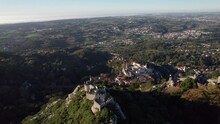 Cinematic Drone Shot Flying Above Ruins Of Castelo Dos Mouros (Moors Castle) And Slowly Revealing Old Town Of Sintra And Vastness Of Landscape, Lisbon, Portugal