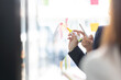 © David - Young creative business Asian woman standing with her colleagues writing new ideas on sticky notes over glass wall, business marketing strategy or User experience ux ui concept.