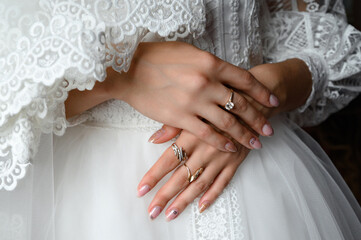 Wall Mural - The bride's hands are detailed, they are laid on dress.