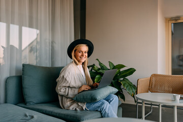 Portrait of a female employer, working at the office, using a la