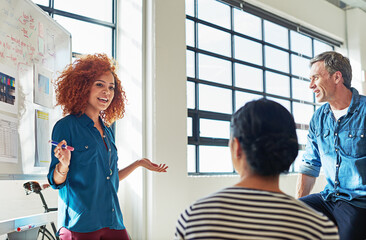 Presentation, training and business woman with a collaboration for a strategy, goal and idea. Meeting, teamwork and creative boss in a workshop with a team writing sales ideas on a whiteboard