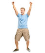 © peopleimages.com - A handsome young man standing alone in the studio with his arms raised in celebration isolated on a PNG background.