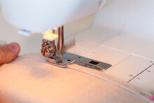 Blurred Sewing Machine Needle Going Into Canvas Fabric