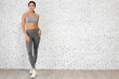 © Art_Photo - Portrait of sport slim fit strength woman workout in sportswear relax and fitness exercise on wall background at home.Diet concept.Fitness and healthy lifestyle