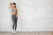 © Art_Photo - Portrait of sport slim fit strength woman workout in sportswear relax and fitness exercise on wall background at home.Diet concept.Fitness and healthy lifestyle