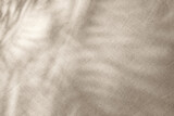 Floral sunlight shadows on a neutral beige cloth, aesthetic minimalist natural background with copy space