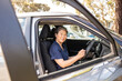 © Austockphoto - Nurse holding the car steering wheel and smiling at the camera