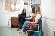 © Austockphoto - Female doctor checking a patient's blood pressure in the clinic