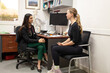 © Austockphoto - female doctor in a clinic with a stethoscope around her neck talking to a woman with a blonde hair
