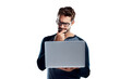© peopleimages.com - A handsome young man using a laptop and looking confused isolated on a PNG background.