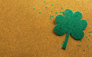 Wall Mural - Happy St Patrick's Day decoration concept made from shamrocks ( clover leaf) on golden background.