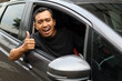 © ArvStd - Happy asian man in the car while showing thumbs up