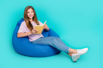 Wall Mural - Full length photo of shiny charming lady wear striped t-shirt bean bag enjoying book empty space isolated turquoise color background