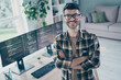 Photo of confident smiling coder dressed eyewear arms folded indoors workplace workstation loft