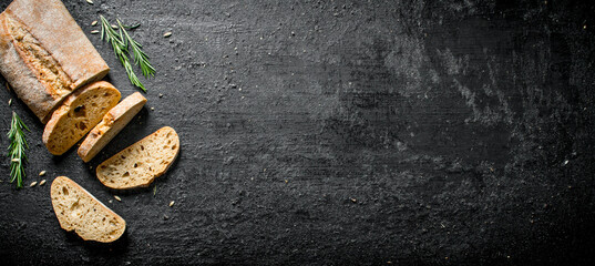 Wall Mural - Pieces of bread ciabatta with rosemary.