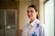 © Suriyo - Woman doctor standing confident in hospital background