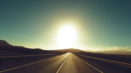 Wall Mural - Warm golden color sunset on the road for travel destination concept in scenic place. Wanderlust. Freedom and future. Sunlight and blue sky in background. Empty road and perspective movement journey.