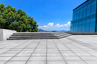 © ABCDstock - Empty square floor and green tree with glass wall scenery in the park