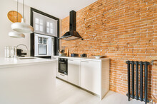 Spacious And Luminous Kitchen With Brick Walls