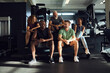 © Flamingo Images - Smiling people sitting on steps at the gym