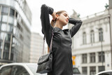 Premium Photo  Stylish beautiful business lady in fashion black clothes  with a dress and a bag walks in a modern city pretty elegant woman